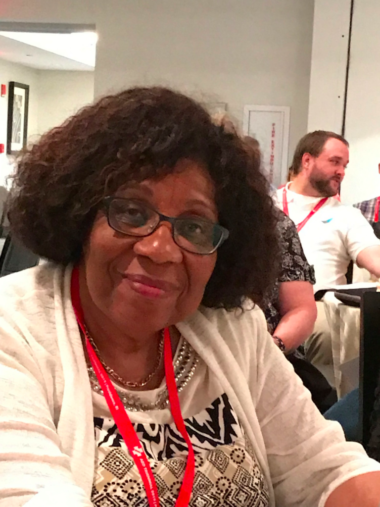 A Black woman smiling warmly.