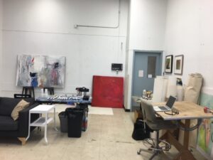 Art studio with tables, chairs, computers, painting materieals